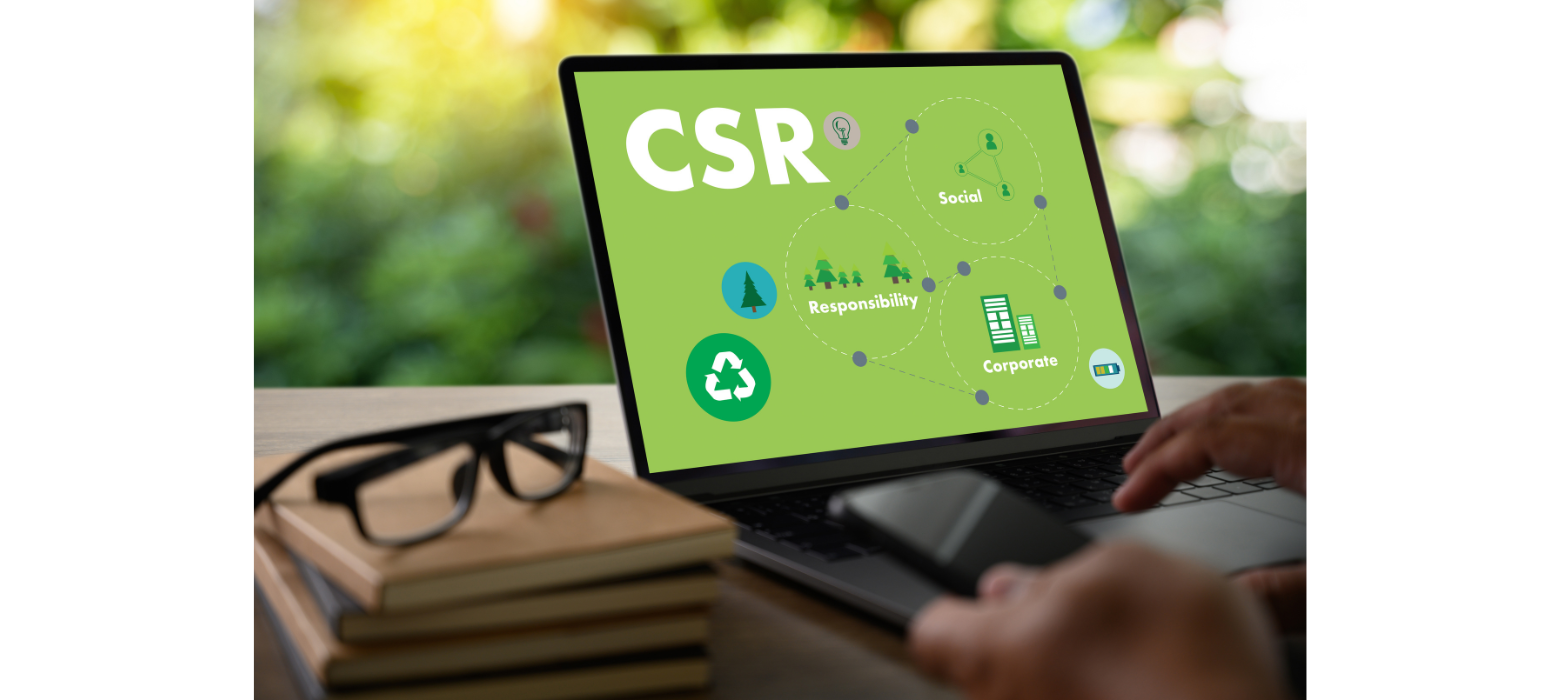 Computer with green background displaying CSR next to black glasses and a hand