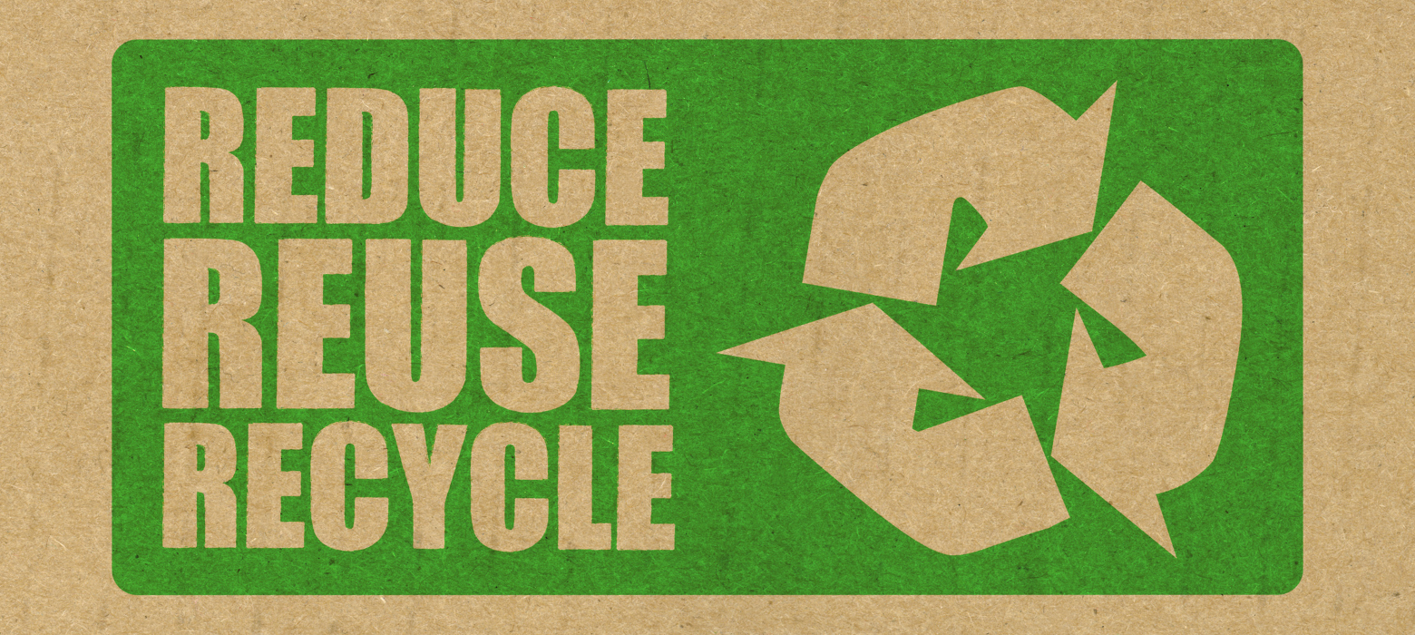 green reduce, reuse, recycle stamp on cardboard