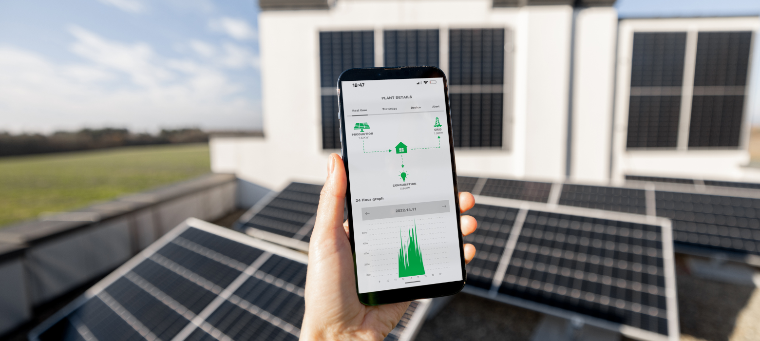 a person holding a smart phone in front of solar panels