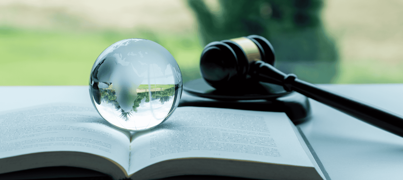 Glass globe on book with wood gavel